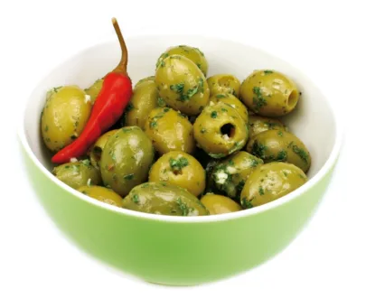 A boll of with green olives and bread.